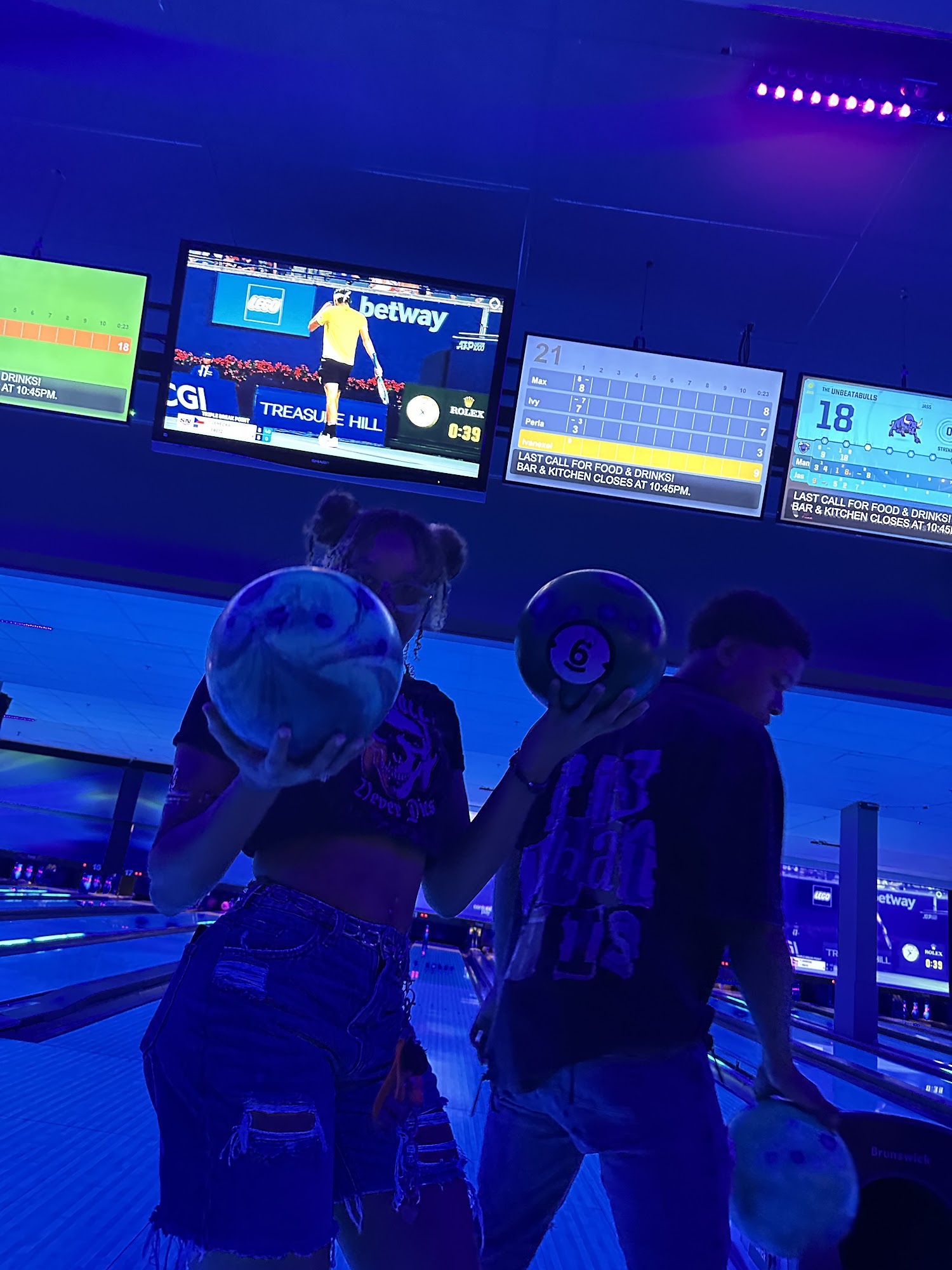 Teenagers having fun bowling at Bowlerland